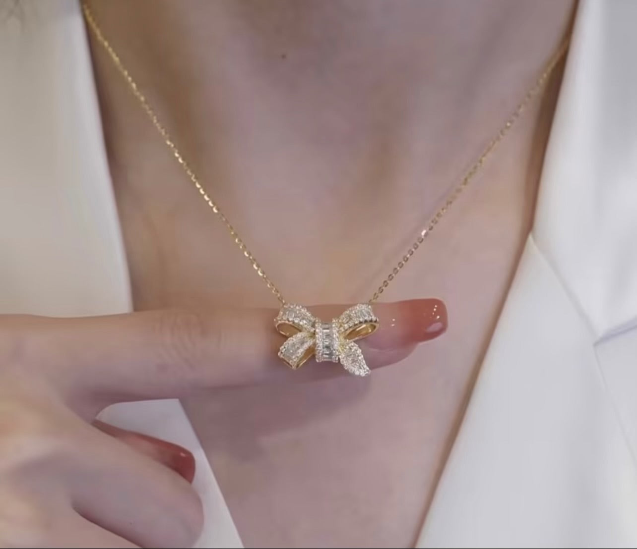 Golden elegant gold necklace with zironic sparkling bow pendant