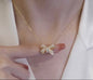 Golden elegant gold necklace with zironic sparkling bow pendant